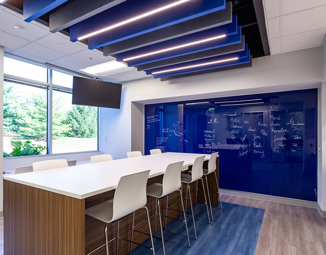 view of a conference room with a blue dry erase board and additional blue accents