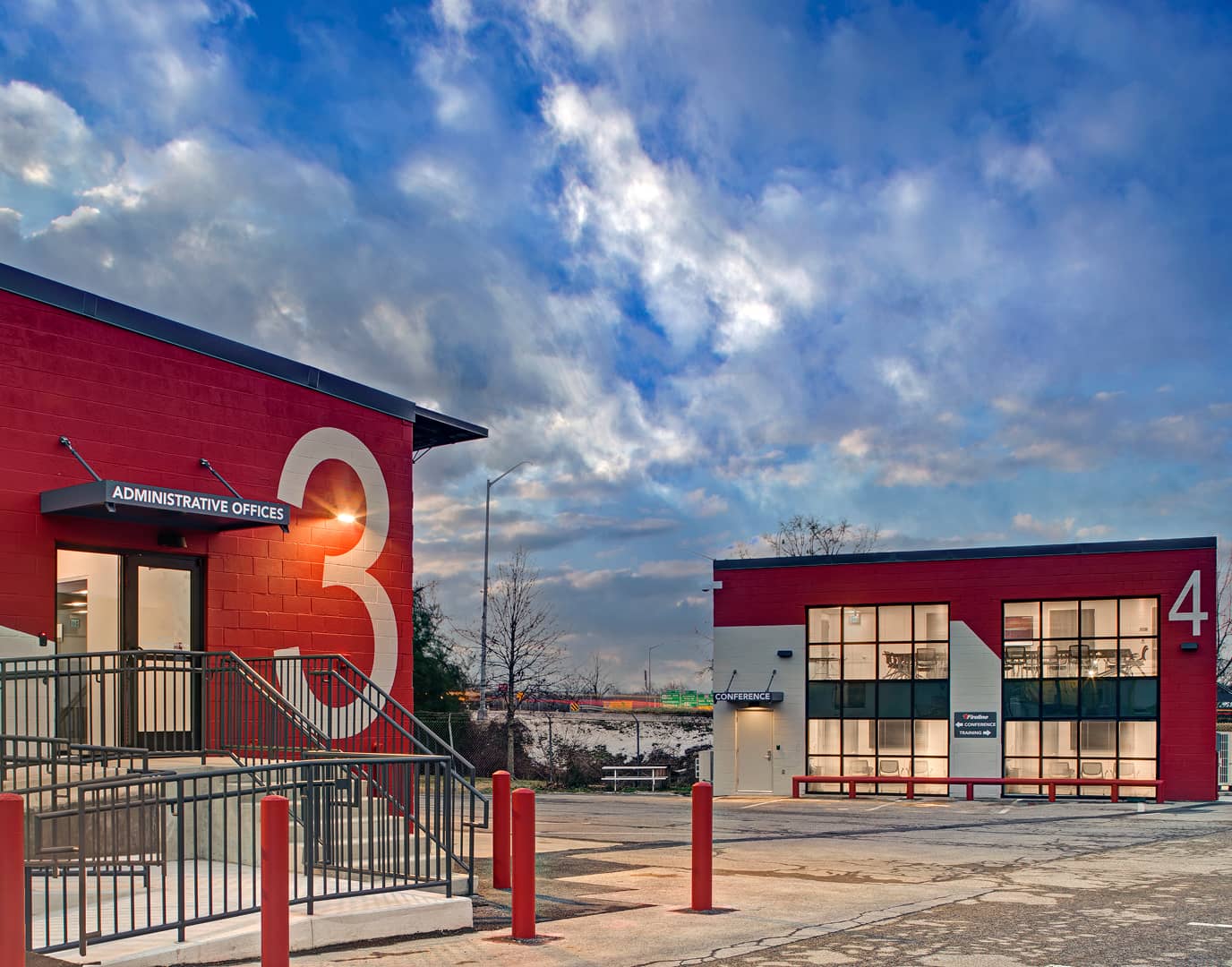 Outside view of the two red buildings with large numbers on the side of each building