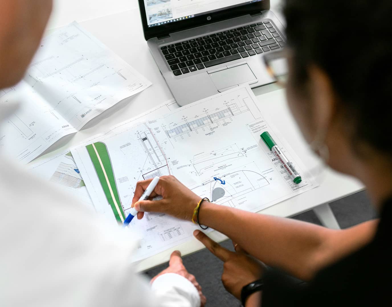 Two architectural designers working on a specs design