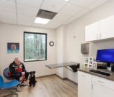 Bayside Animal Medical Center patient room with black dog
