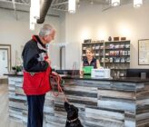 Bayside Animal Medical Center lobby with black dog and owner