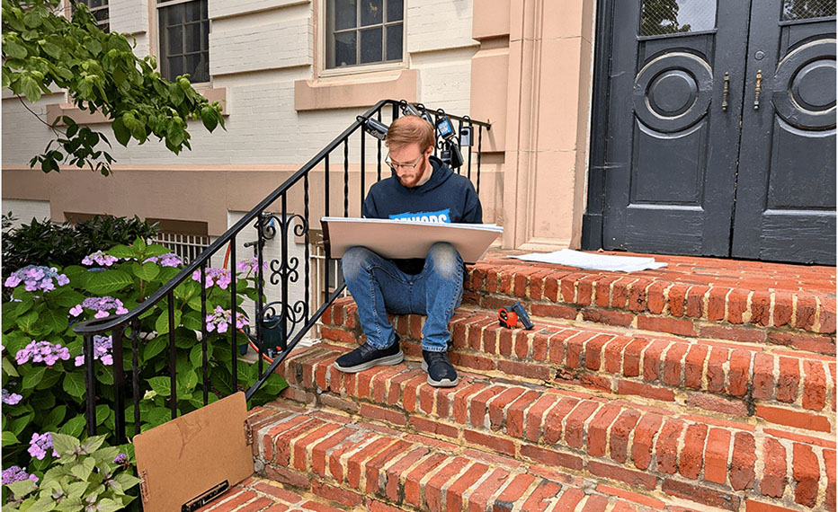 Arium AE survey work with architect sitting on brick steps