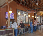 Checkerspot Brewery interior of people talking along bar