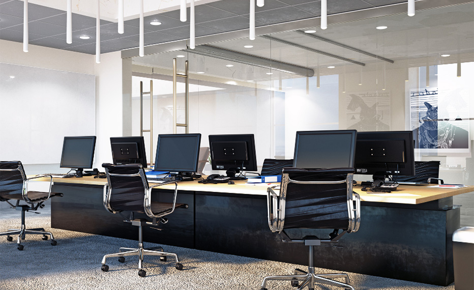 desk and black chairs in open office space