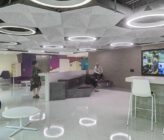 Leidos Annex presentation room in break area with people sitting and standing
