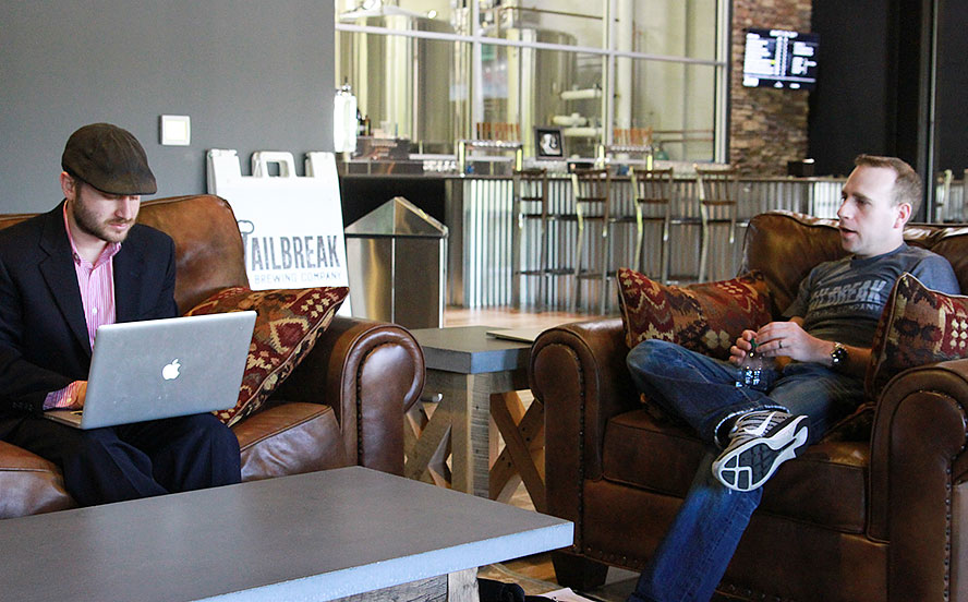 Jailbreak Brewing Company interior with cofounders sitting on couch