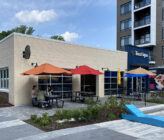 Tostique exterior with bright colored umbrellas and tables