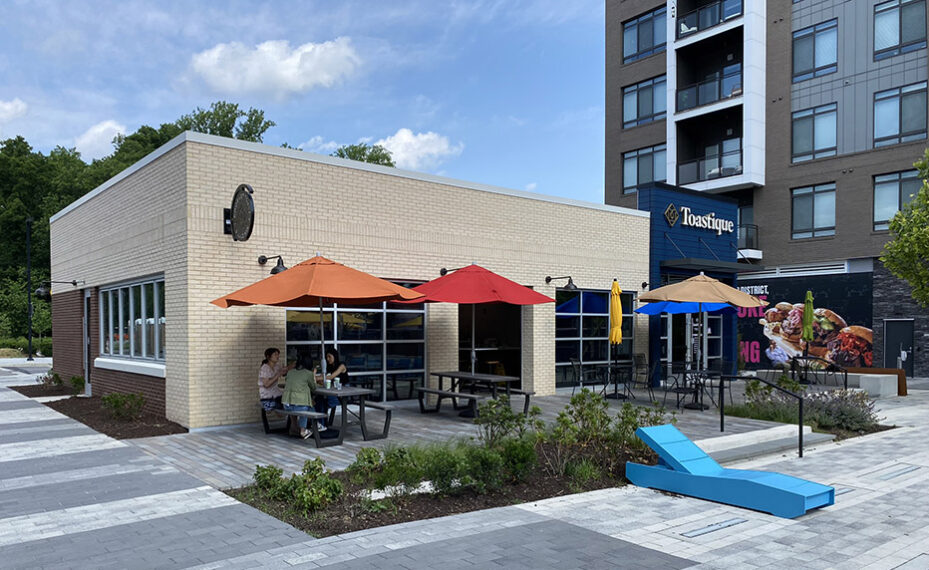 Tostique exterior with bright colored umbrellas and tables