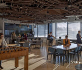 Global Technology Company interior breakroom with people at tables talking