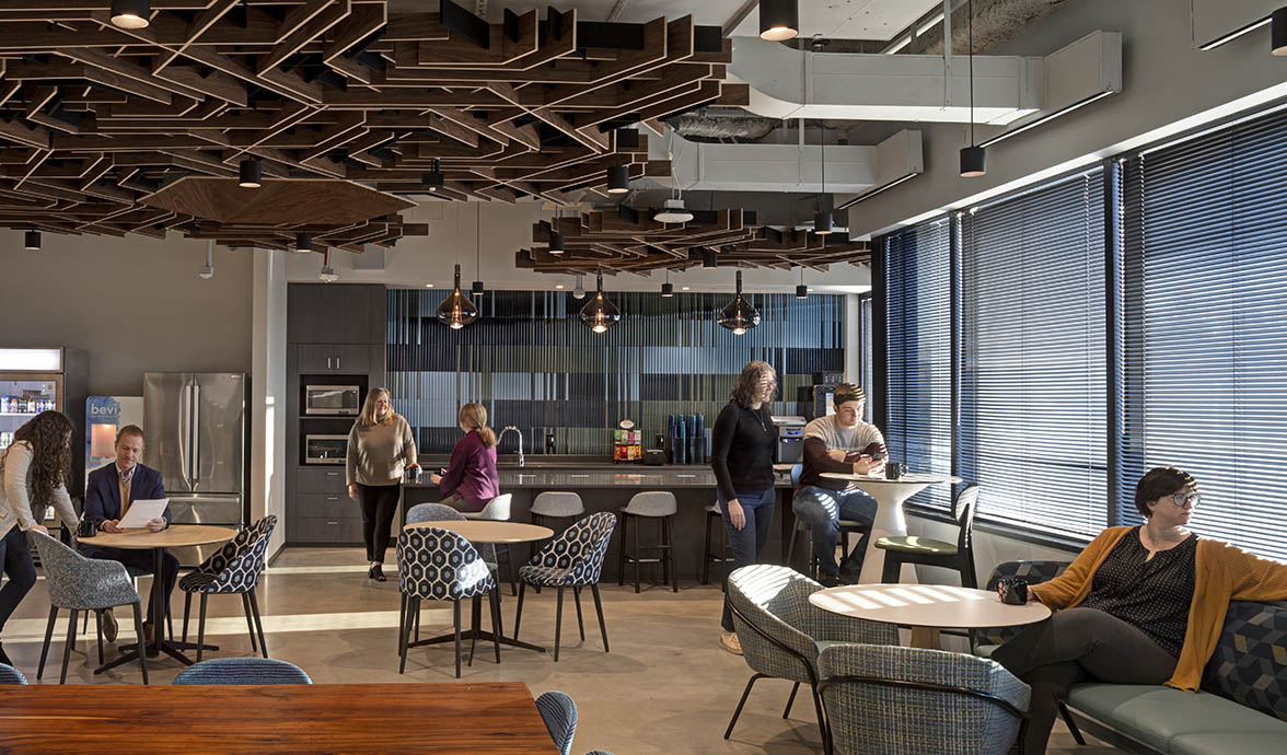 Global Technology Company interior breakroom with people chatting front view