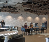 Global Technology Company interior breakroom with people at tables talking